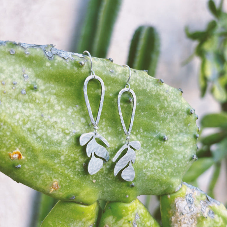 Silver Matisse Earrings hang from a cactus in Mexico