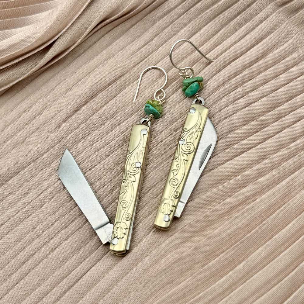 Etched Gold Handle Working PocketKnife hanging from ear wire with turquoise stone