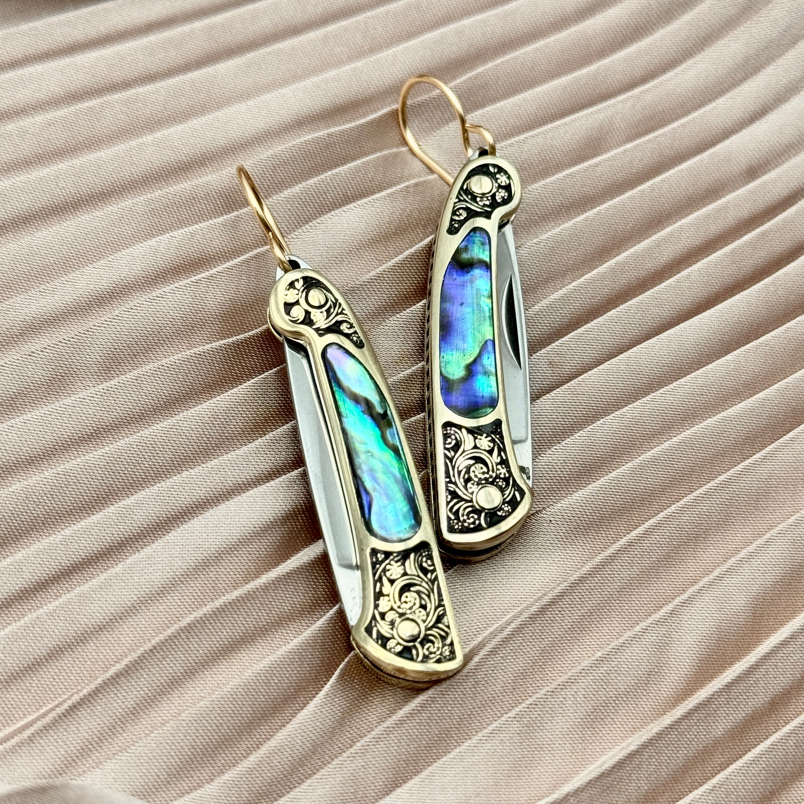 Abalone inlay and vintage inspired etched gold handle on a working pocketknife hanging from an ear wire