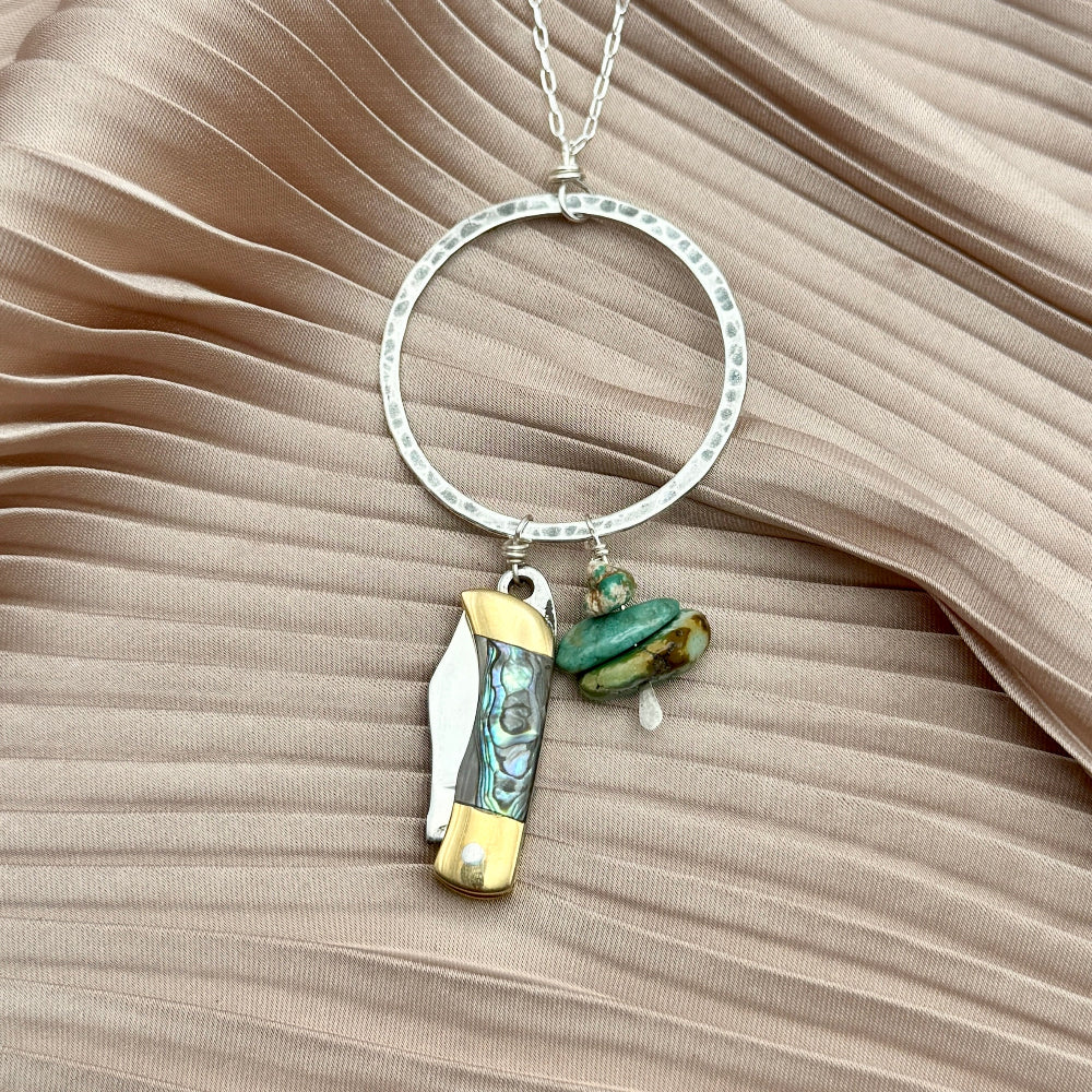 necklace with small abalone inlay pocketknife and two turquoise bead chips hanging from round open circle pendant