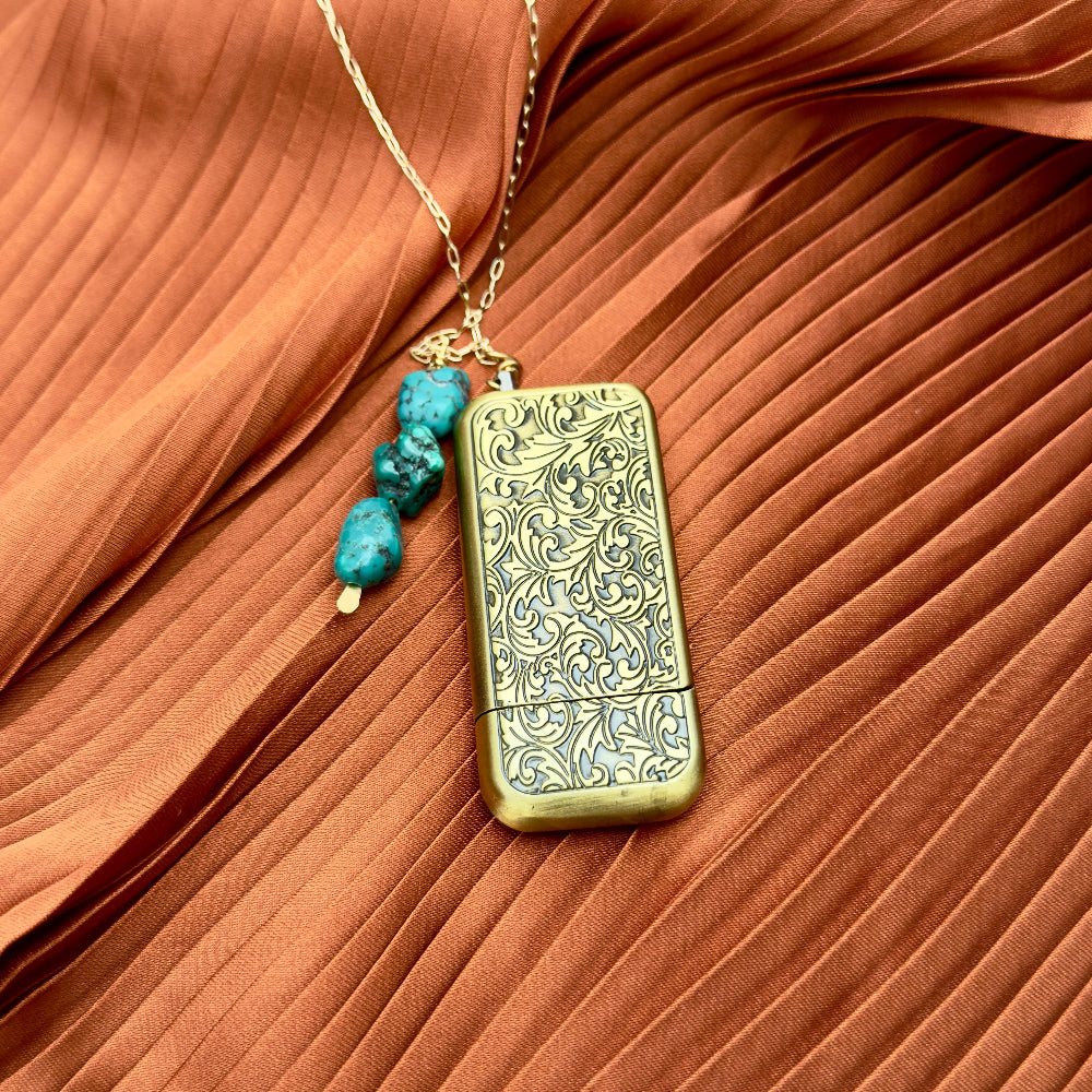 Brass engraved lighter with turquoise stones on a gold necklace chain