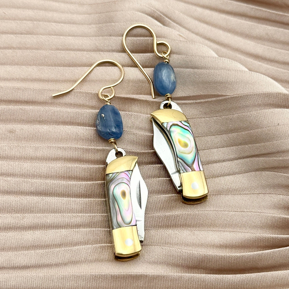 Abalone inlay pocket knife with kyanite bead earrings hanging on gold ear wire