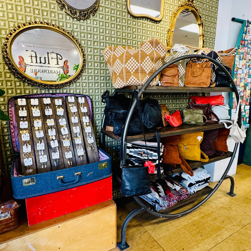 Vintage-style store interior with shelves displaying leather bags and travel duffels.