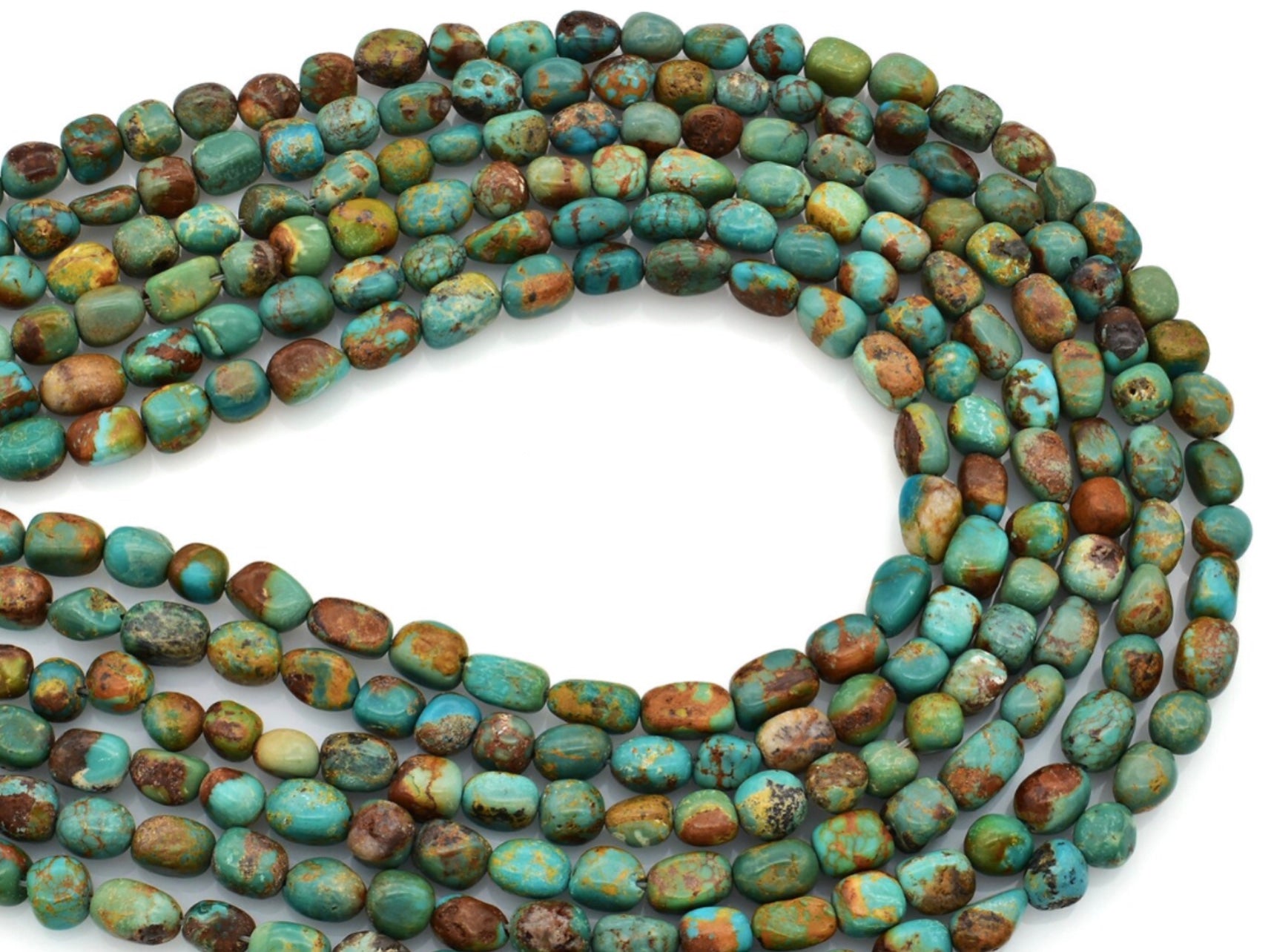 The Alpine Earrings by Fluff Hardware feature small, oval turquoise beads in blue, green, and brown hues with natural marbling, arranged in overlapping loops and accented with sterling silver.