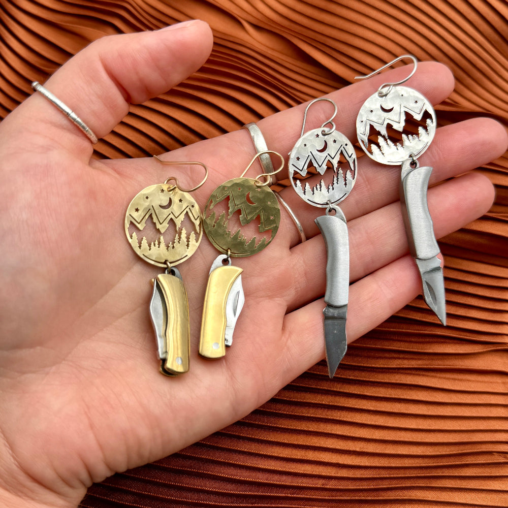 Mountain Night Moon Pine tree pendant hanging from ear wire with miniature billie gold or silver pocketknives