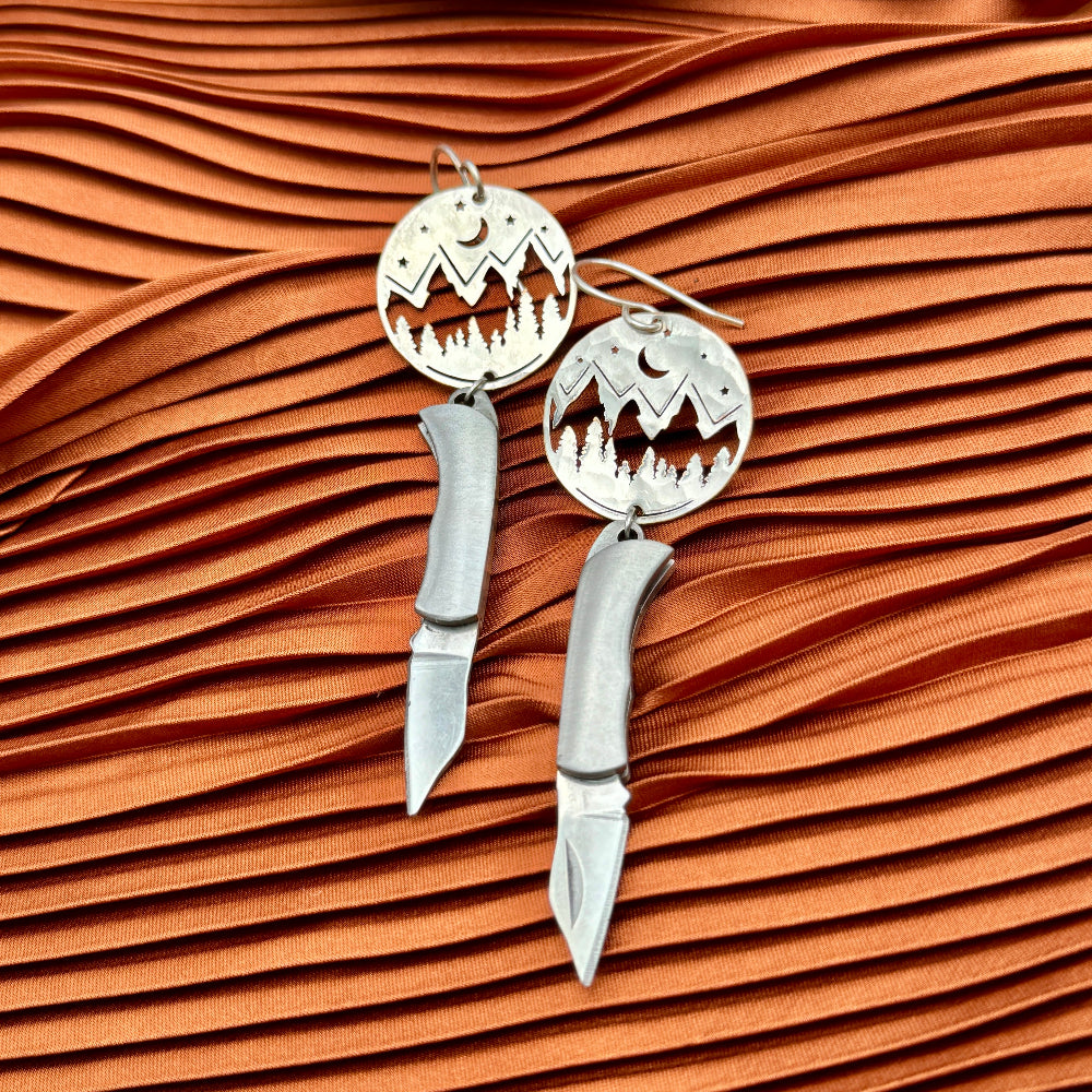 Mountain Night Moon Pine tree pendant hanging from ear wire with miniature billie gold or silver pocketknives