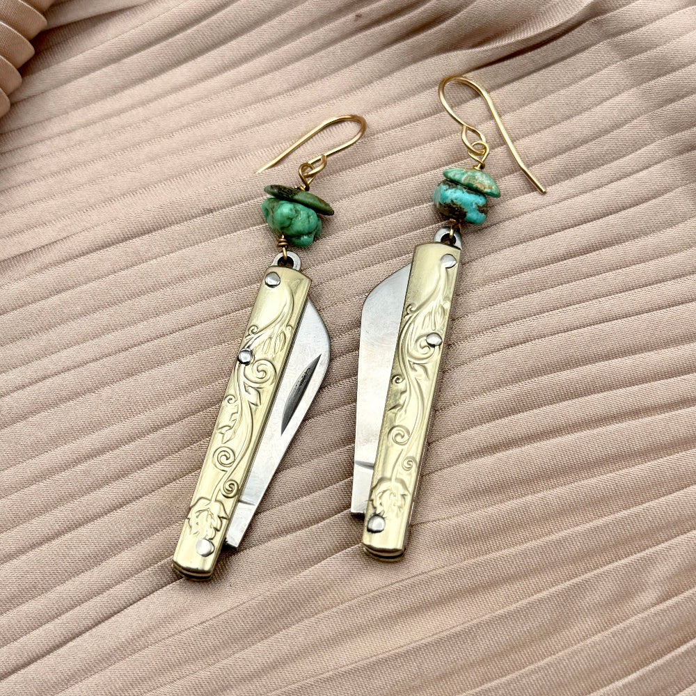 Etched Gold Handle Working PocketKnife hanging from ear wire with turquoise stone