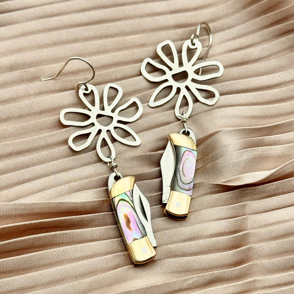 Silver flower pendant with abalone billie pocketknife earrings with the blades closed in