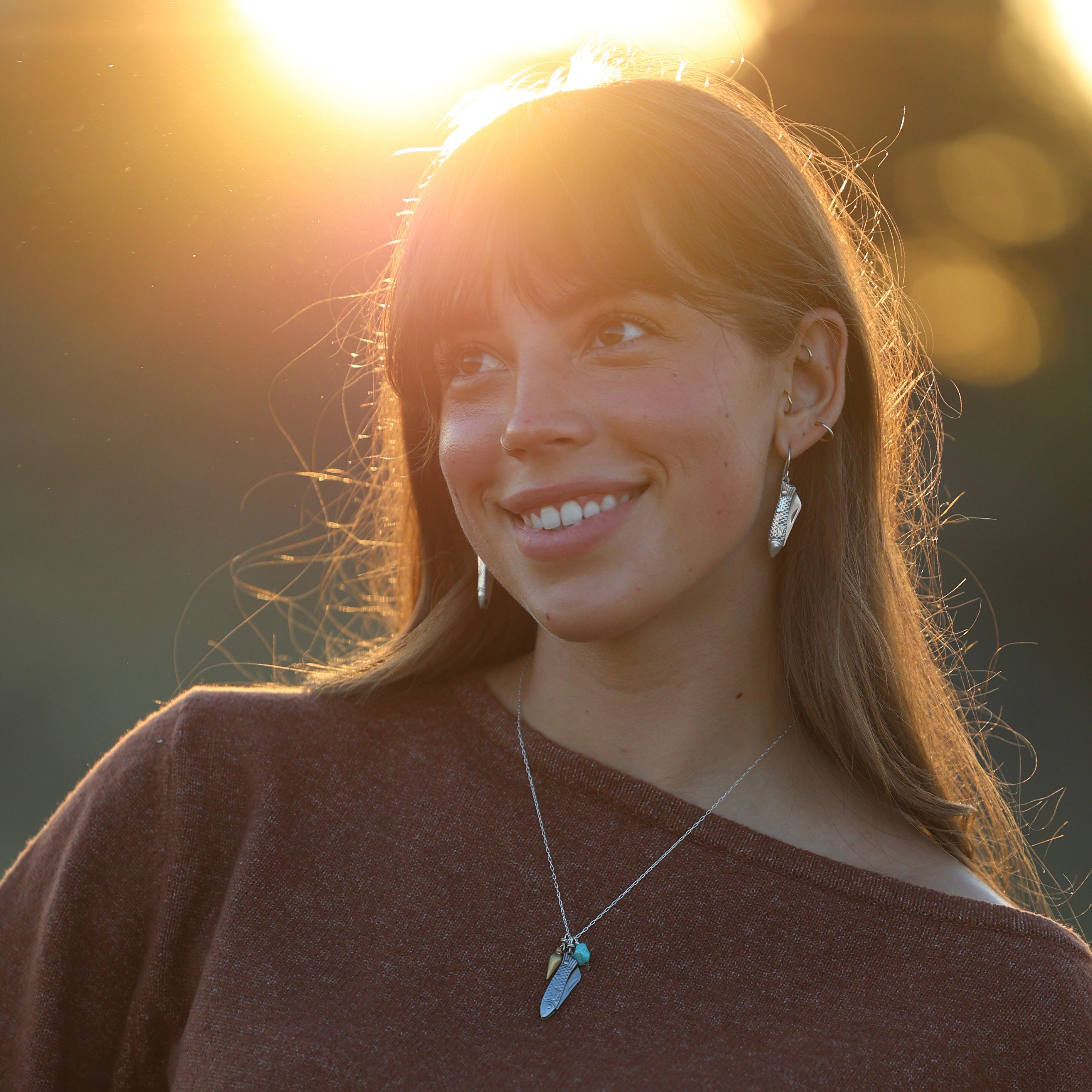 Working fish shaped pocketknife with a bullet shaped pendant and turquoise bead