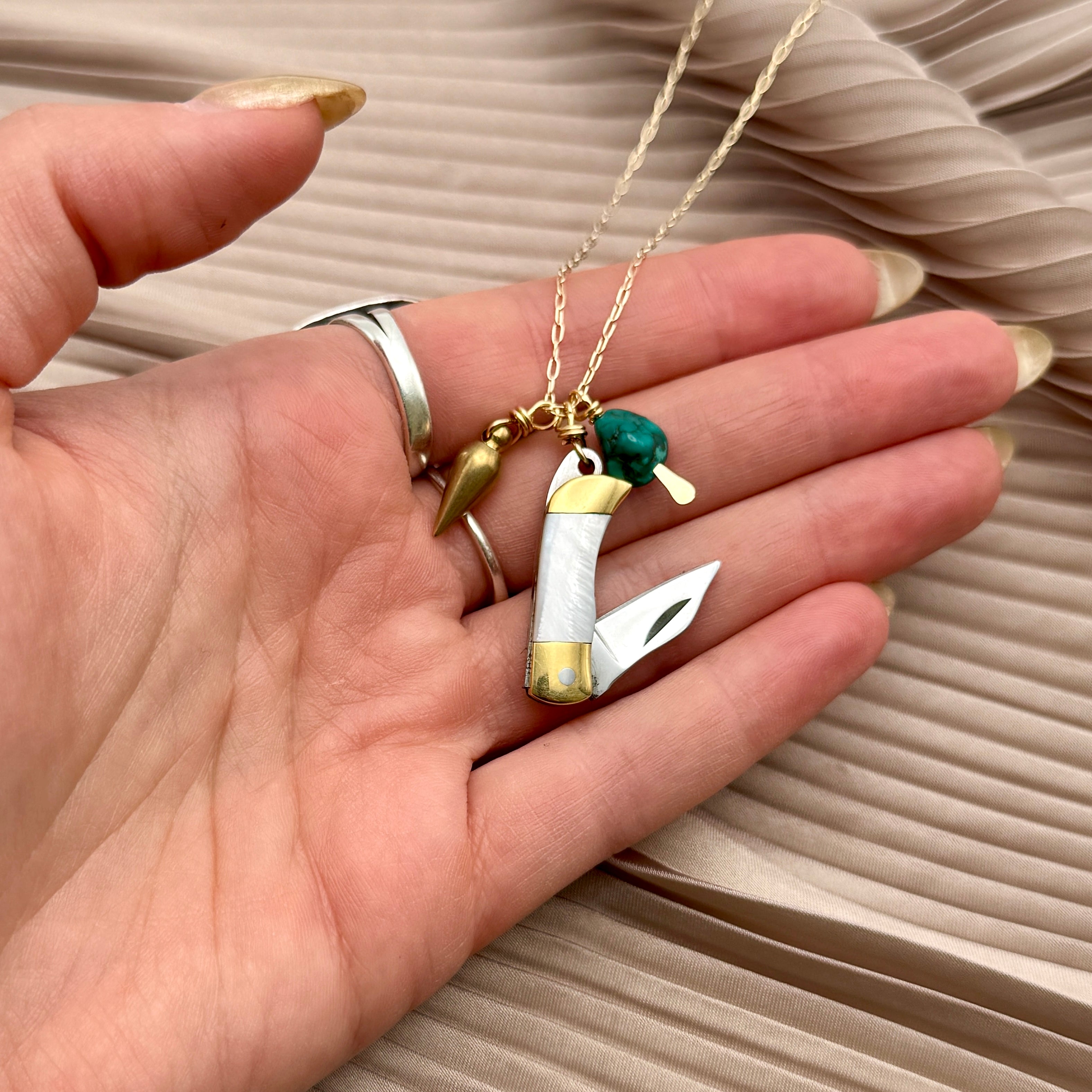 Miniature Pocketknife with mother of pearl inlay and a turquoise stone and mini bullet hanging from sterling silver or gold chain