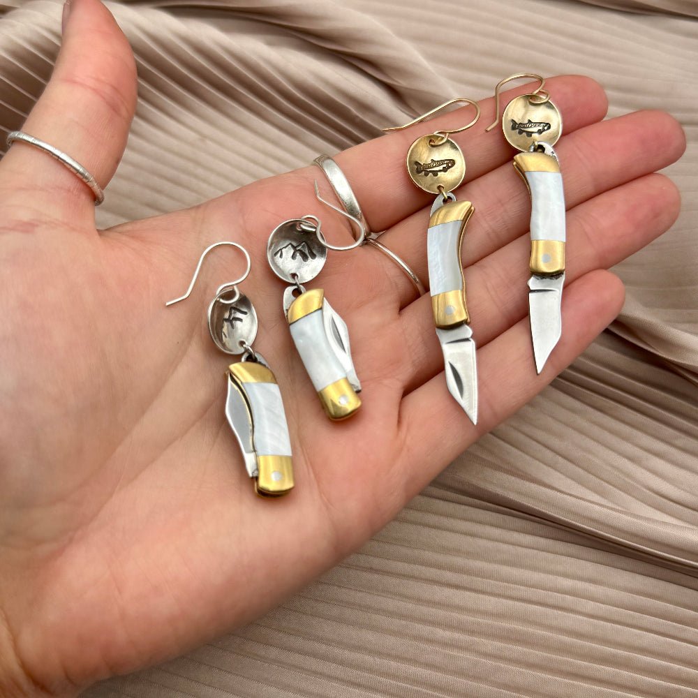 Mini pocket knife with mother of pearl inlay hanging from stamped fish flower mountain or tree circle pendant
