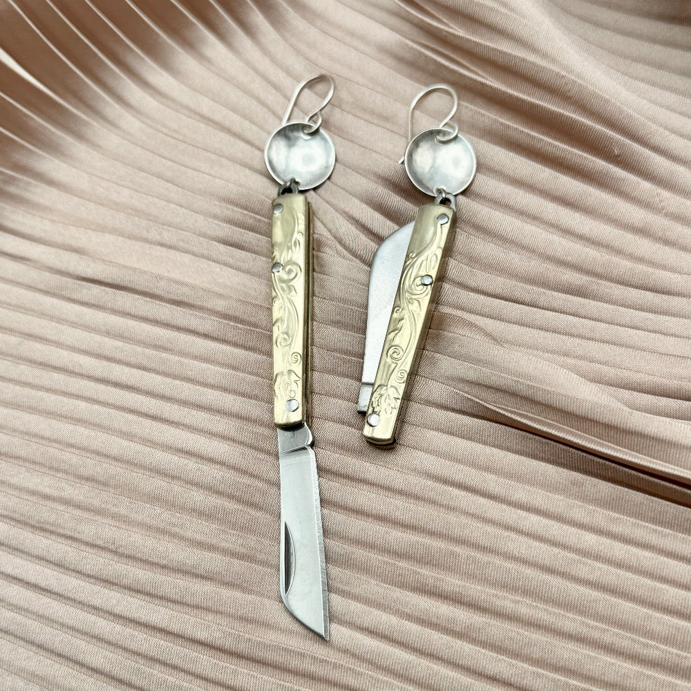 Etched Gold Handle Working PocketKnife hanging from ear wire with circle