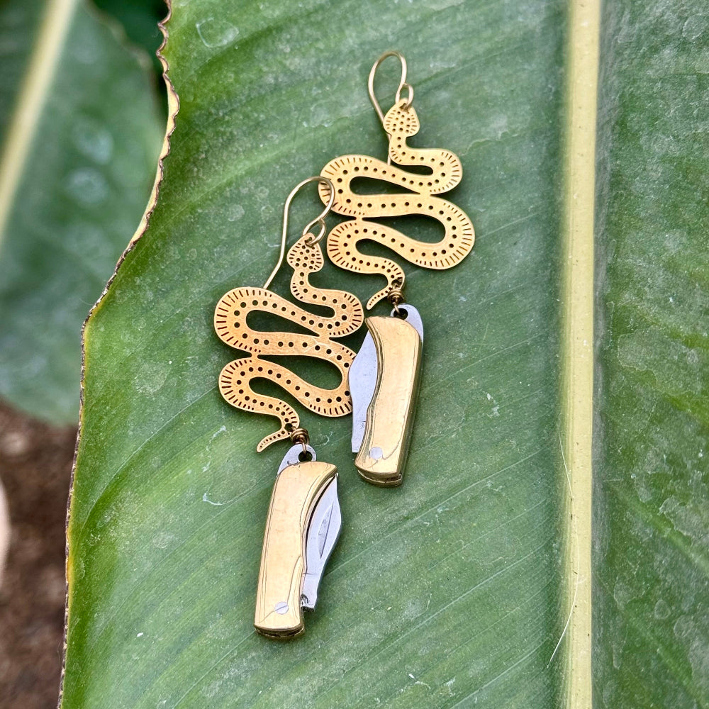 Silver or gold metal working pocketknives hanging from silver or gold snake pending on an ear wire