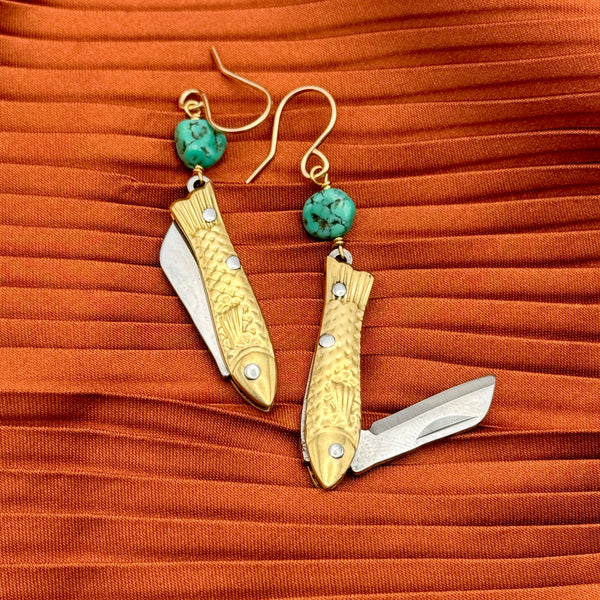 A pair of earrings featuring gold-colored miniature fish shaped utility working pocket knife with turquoise nuggets on a sterling silver or 14 karat gold fill ear wire