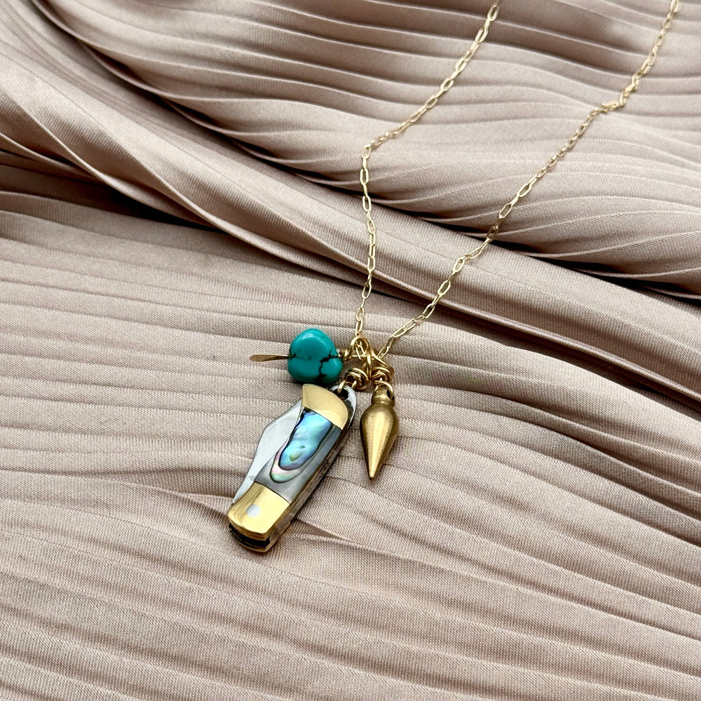 Abalone inlay and gold handle miniature pocketknife hanging with a turquoise stone and mini bullet