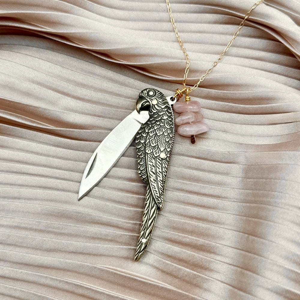 Parrot bird shaped brass pocketknife pendant with rose quartz beads on necklace chain with knives open