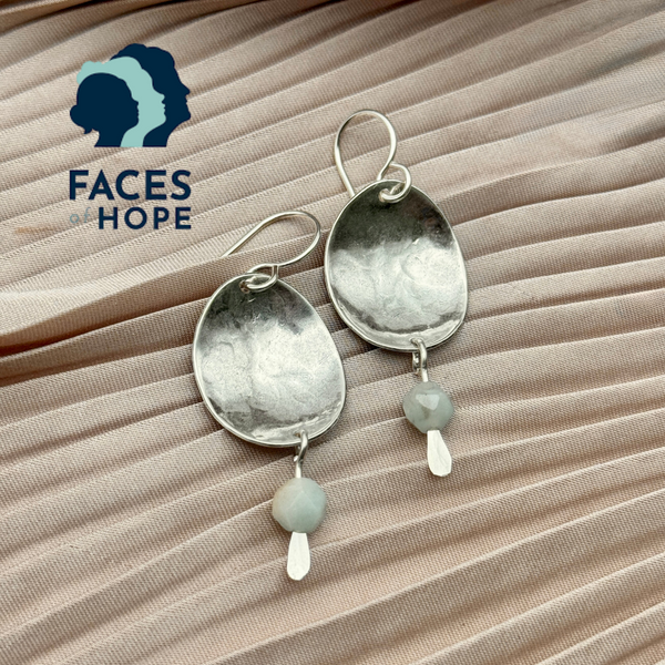 silver dapped oval earrings with a light blue amazonite bead dangle