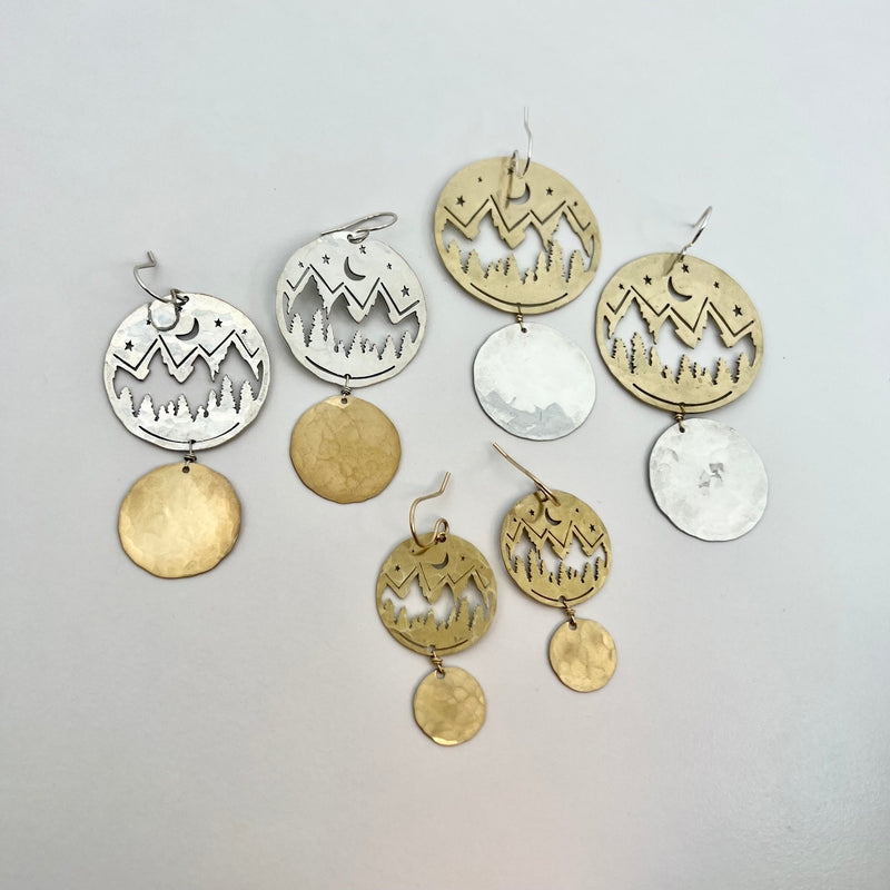 gold and silver earrings with mountain silhouette 