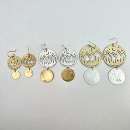 gold and silver earrings with mountain silhouette 