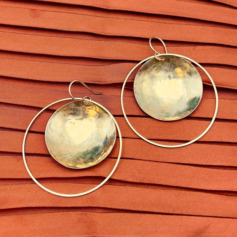 medium sized earrings with brass disk inside a hoop